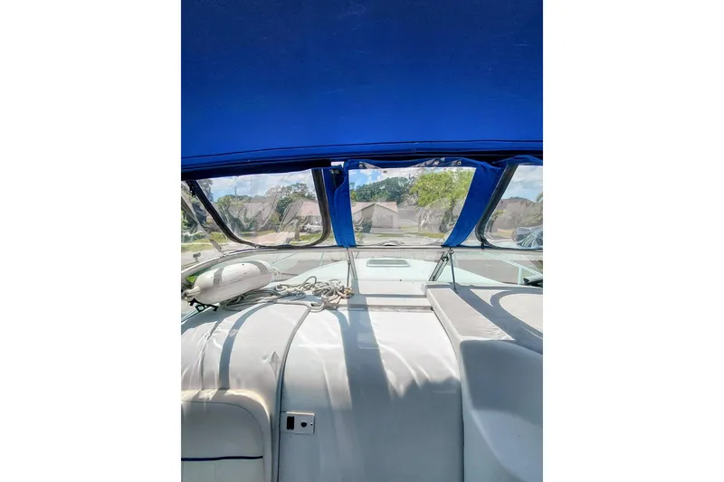 Slide: The Image of Interior view of a 2000 Crownline 242 CR boat with blue canopy. - 18