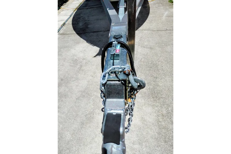 Slide: The Image of Trailer hitch of a 2000 Crownline 242 CR boat on concrete surface. - 21