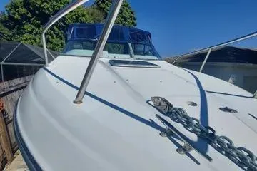Slide: The Image of 2000 Crownline 242 CR boat with blue canopy and anchor chain on deck. - 6