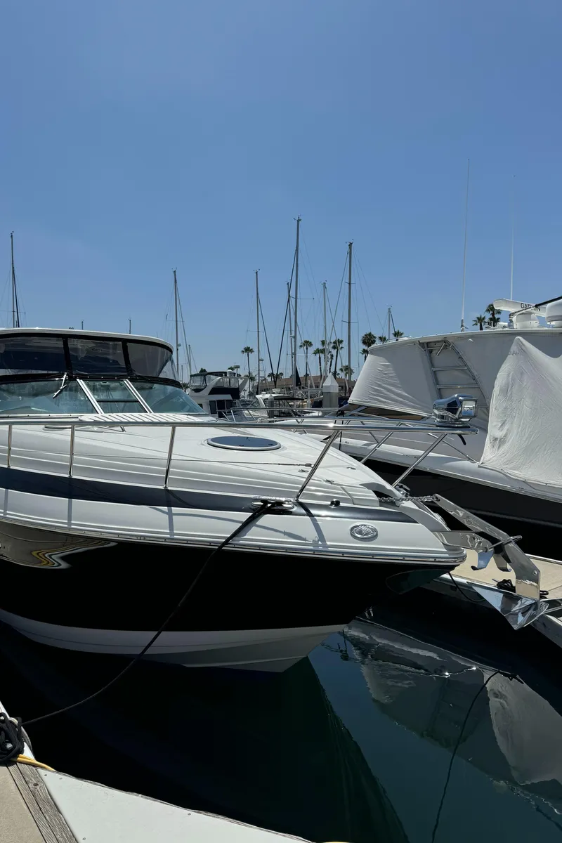 Slide: The Image of 2018 Crownline 350 SY yacht docked in a marina under clear blue skies. - 19