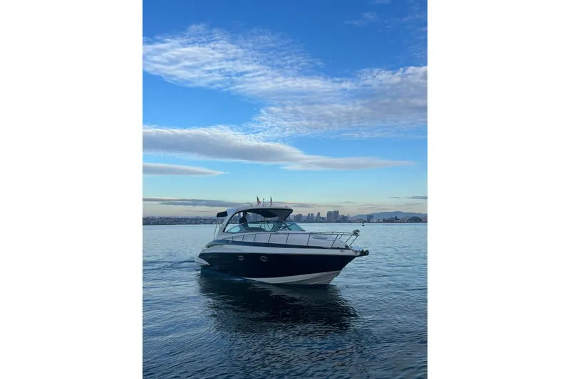 Slide: The Image of 2018 Crownline 350 SY yacht cruising on calm waters under a blue sky. - 2