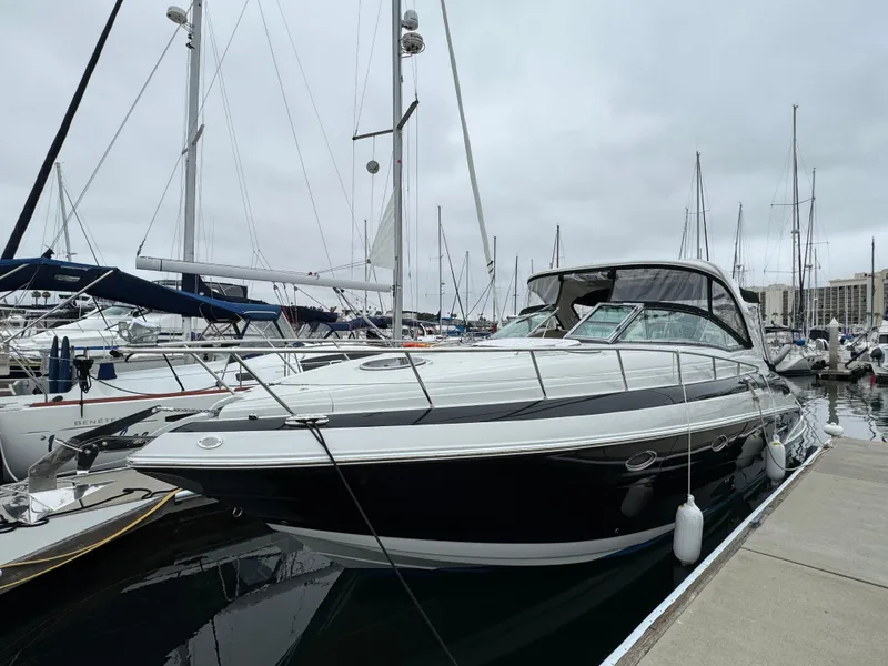 Slide: The Image of 2018 Crownline 350 SY yacht docked at a marina, surrounded by sailboats. - 3