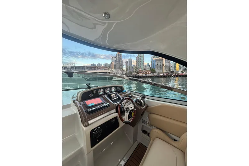 Slide: The Image of Interior view of 2018 Crownline 350 SY yacht cockpit with city skyline in background. - 32