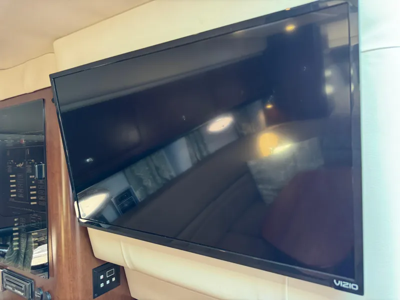 Slide: The Image of Flat-screen TV inside 2018 Crownline 350 SY yacht cabin, featuring a Vizio display. - 50