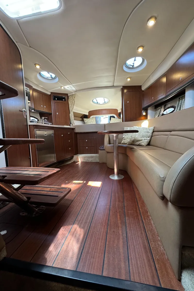 Slide: The Image of 2018 Crownline 350 SY yacht interior with elegant wood flooring and modern furnishings. - 51