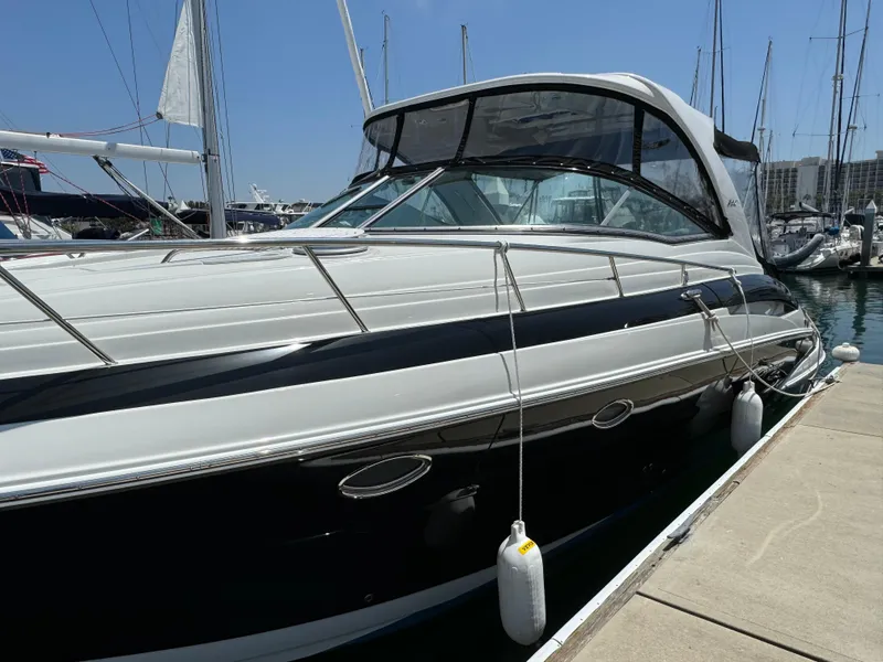 Slide: The Image of 2018 Crownline 350 SY yacht docked at marina under clear blue sky. - 6