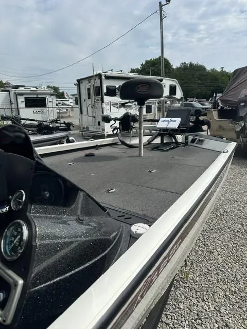 Slide: The Image of 2018 Ranger Tournament RT198P boat parked on gravel lot. - 12