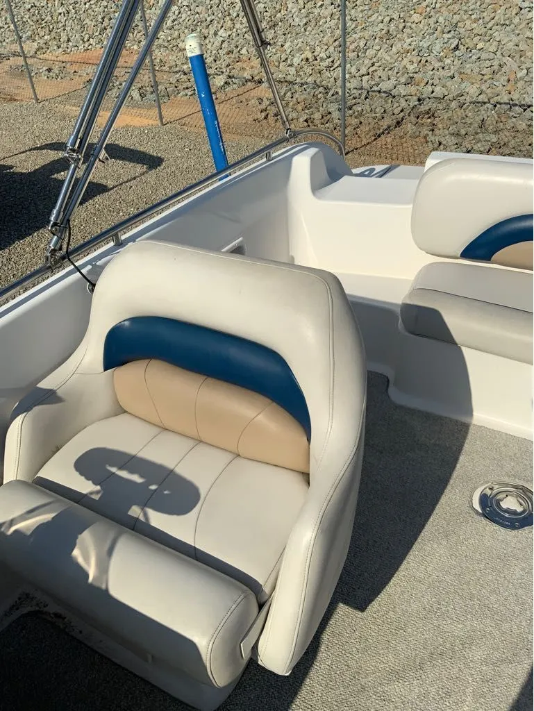 Slide: The Image of Interior of a 2006 Hurricane GS232 boat with beige and blue seating. - 9