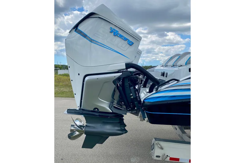 Slide: The Image of 2024 MTI V50 boat engine with sleek design and blue accents under a cloudy sky. - 10