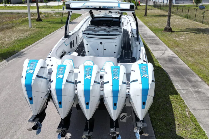Slide: The Image of 2024 MTI V50 boat with Stephen Miles Design, featuring sleek blue and white accents. - 12