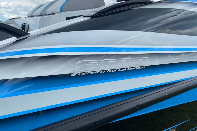 Slide: The Image of 2024 MTI V50 boat with sleek design, spacious deck, and modern features under a blue sky. - 13