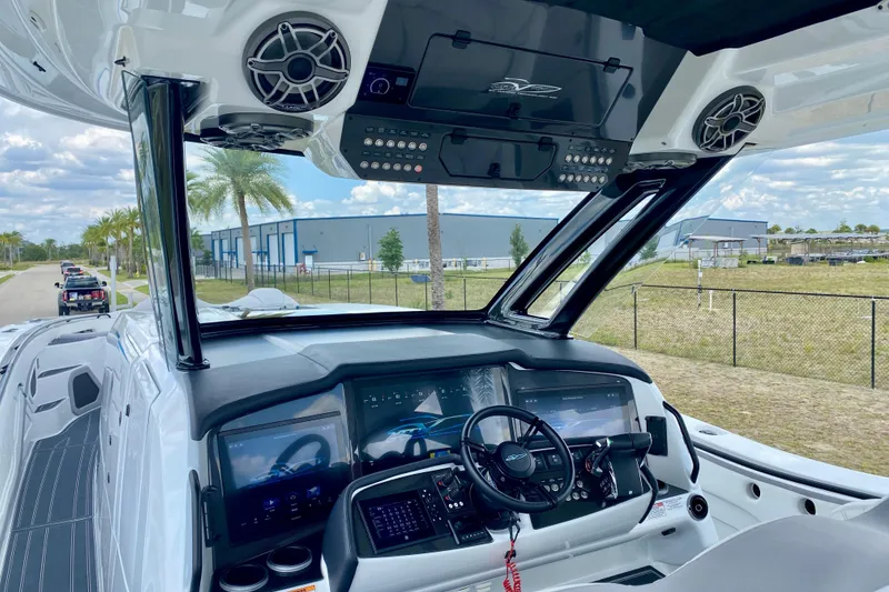 Slide: The Image of 2024 MTI V50 boat cockpit with modern controls and seating, under a clear blue sky. - 15