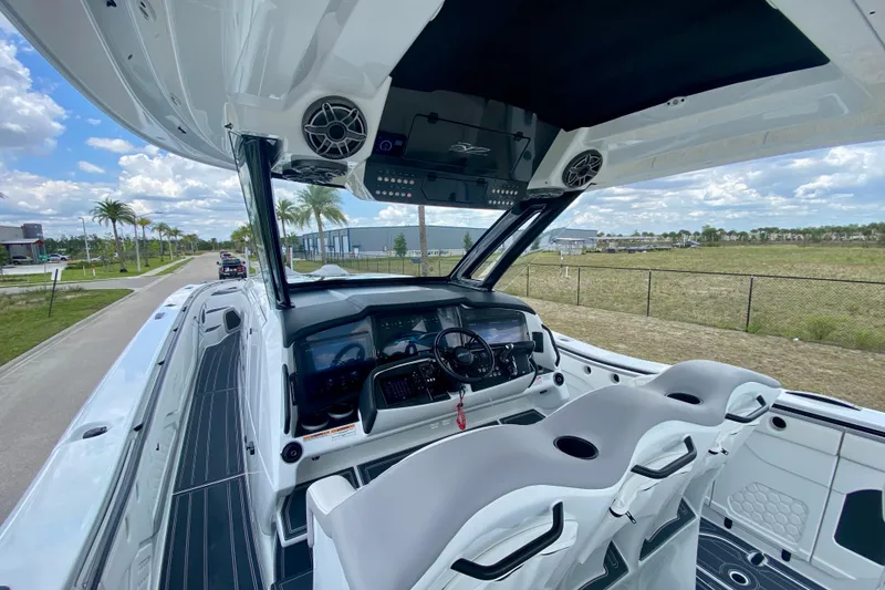Slide: The Image of 2024 MTI V50 boat interior with luxurious seating and advanced controls. - 16