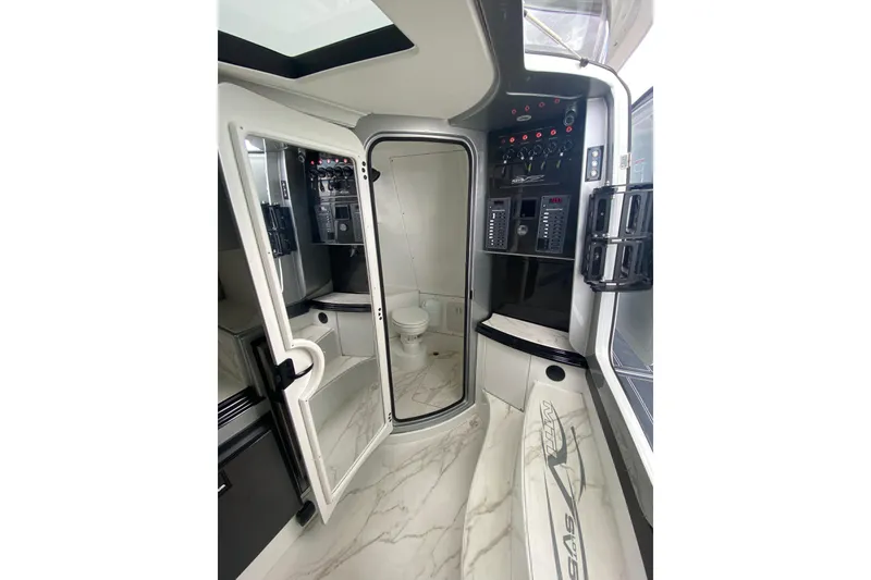 Slide: The Image of Luxurious interior of 2024 MTI V50 boat featuring modern control panels and sleek design. - 23
