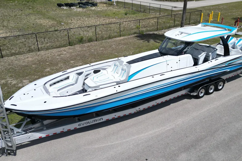 Slide: The Image of 2024 MTI V50 boat on trailer, featuring sleek white and blue design. - 3