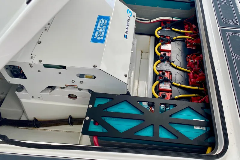 Slide: The Image of 2024 MTI V50 boat covered in a protective tarp on a trailer indoors. - 32