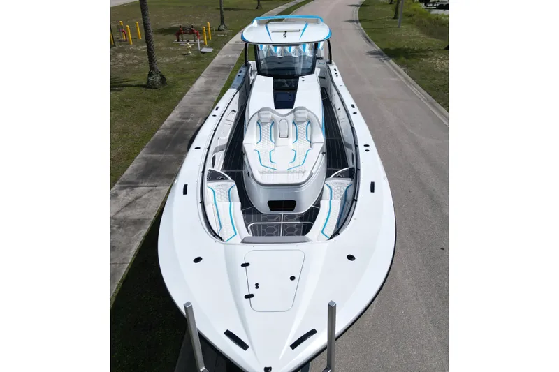 Slide: The Image of 2024 MTI V50 boat with sleek design and modern seating on a road. - 5