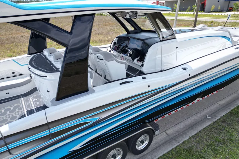 Slide: The Image of 2024 MTI V50 boat with sleek design, modern interior, and vibrant blue accents. - 7