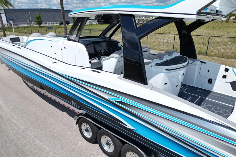Slide: The Image of 2024 MTI V50 boat with sleek design, blue accents, and modern cockpit. - 8