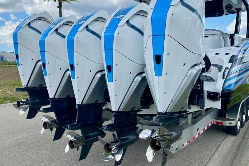 Slide: The Image of Four powerful outboard motors on a 2024 MTI V50 boat, showcasing sleek design and performance. - 9