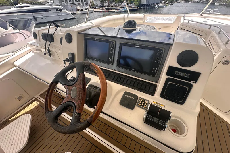 Slide: The Image of Cockpit of 2006 Sea Ray 58 Sedan Bridge with steering wheel and navigation controls. - 10