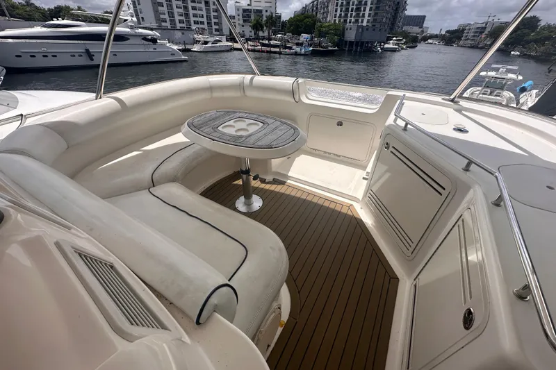 Slide: The Image of 2006 Sea Ray 58 Sedan Bridge yacht interior with seating and table, docked in marina. - 11