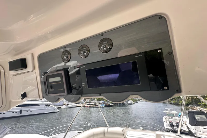 Slide: The Image of Control panel of a 2006 Sea Ray 58 Sedan Bridge yacht, overlooking a marina. - 14