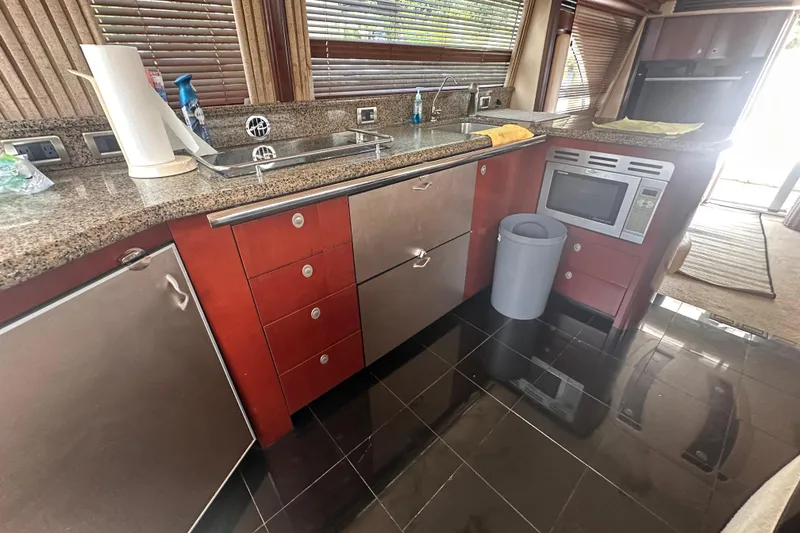 Slide: The Image of Luxurious kitchen interior of 2006 Sea Ray 58 Sedan Bridge yacht with modern appliances. - 23
