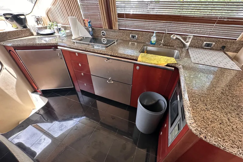 Slide: The Image of Luxurious kitchen interior of 2006 Sea Ray 58 Sedan Bridge yacht with granite countertops. - 25