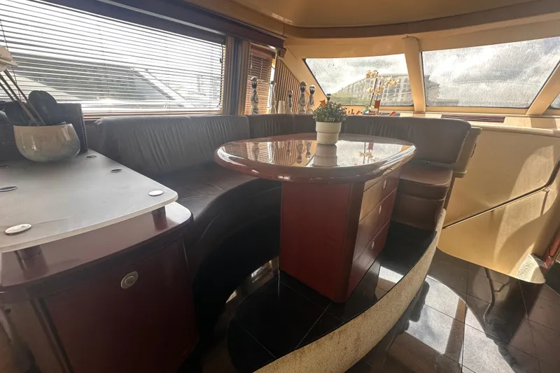 Slide: The Image of Luxurious interior of a 2006 Sea Ray 58 Sedan Bridge yacht with elegant seating and table. - 26