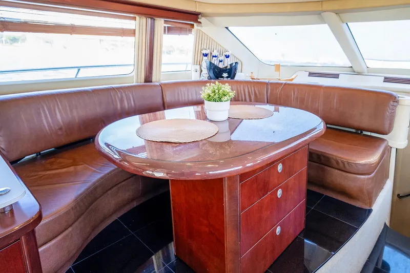 Slide: The Image of Luxurious 2006 Sea Ray 58 Sedan Bridge yacht interior with elegant dining area and leather seating. - 27