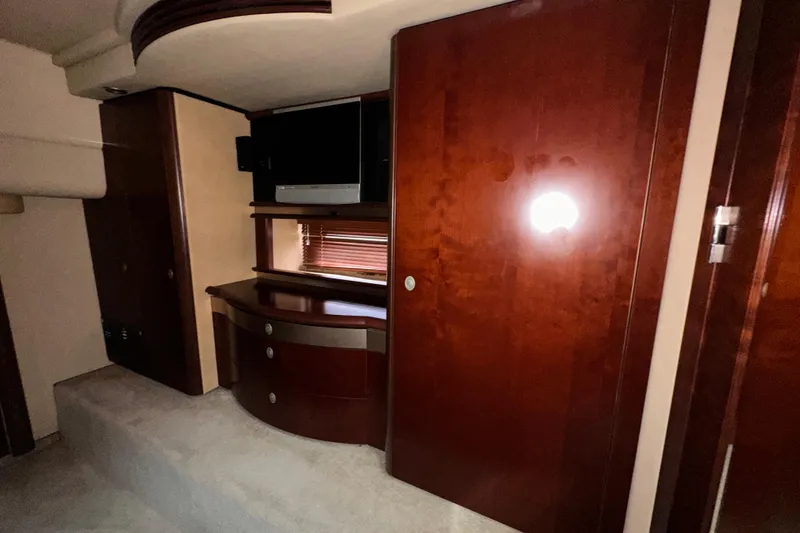 Slide: The Image of Luxurious interior of 2006 Sea Ray 58 Sedan Bridge with wood cabinetry and TV. - 31