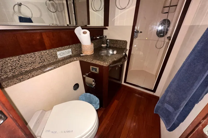 Slide: The Image of Luxurious bathroom in 2006 Sea Ray 58 Sedan Bridge yacht with granite countertop and shower. - 32