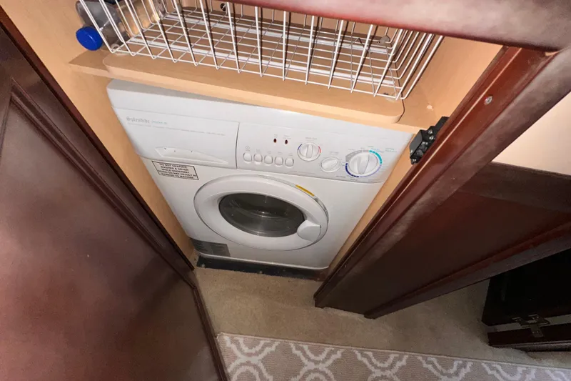 Slide: The Image of Laundry area with Electrolux washer in 2006 Sea Ray 58 Sedan Bridge yacht. - 39