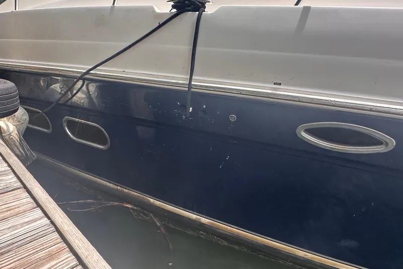 Slide: The Image of Side view of a 2006 Sea Ray 58 Sedan Bridge yacht docked. - 4