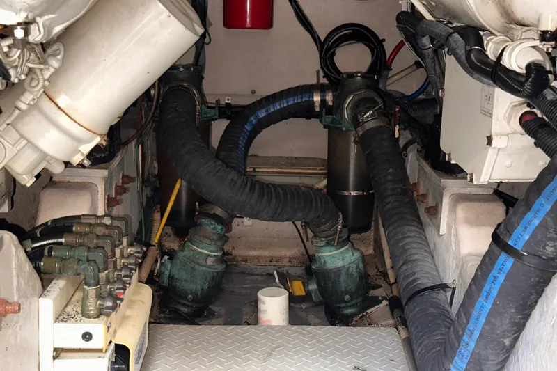 Slide: The Image of Engine room of a 2006 Sea Ray 58 Sedan Bridge with visible hoses and machinery. - 47