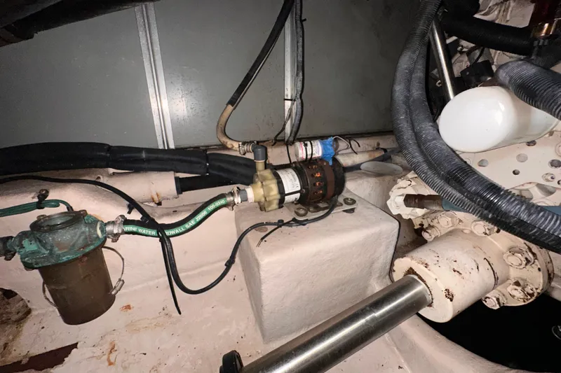 Slide: The Image of Engine room of a 2006 Sea Ray 58 Sedan Bridge, showcasing mechanical components and hoses. - 48