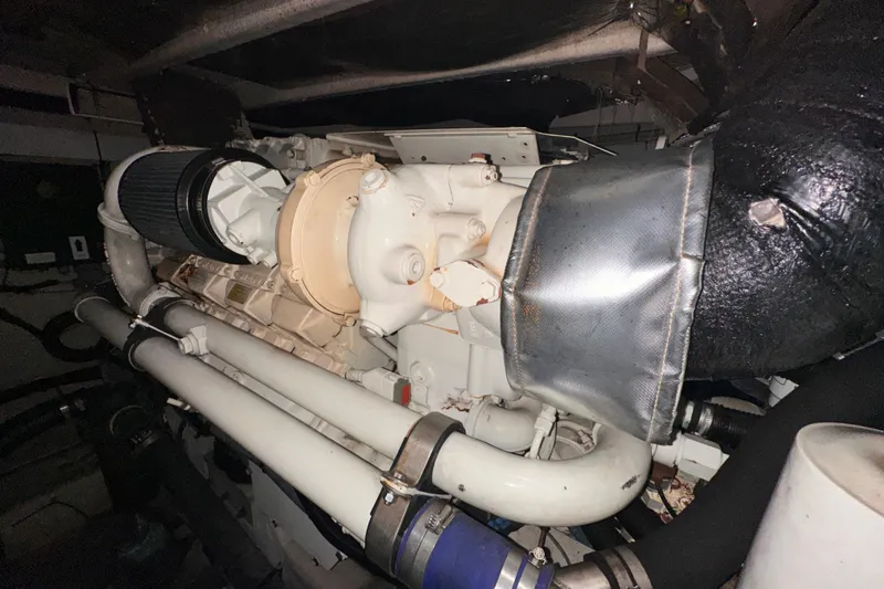 Slide: The Image of Engine compartment of a 2006 Sea Ray 58 Sedan Bridge yacht, showcasing mechanical components. - 49