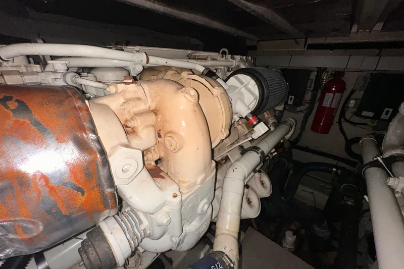 Slide: The Image of Engine room of a 2006 Sea Ray 58 Sedan Bridge yacht, showing mechanical components and piping. - 50