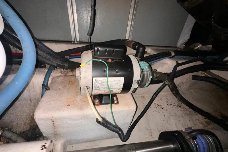 Slide: The Image of Engine compartment of a 2006 Sea Ray 58 Sedan Bridge with visible wiring and components. - 51