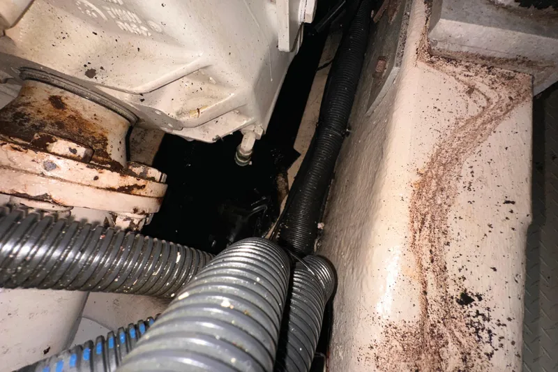 Slide: The Image of Engine compartment of a 2006 Sea Ray 58 Sedan Bridge with visible rust and hoses. - 52