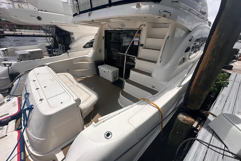 Slide: The Image of 2006 Sea Ray 58 Sedan Bridge yacht docked, featuring spacious deck and elegant design. - 7