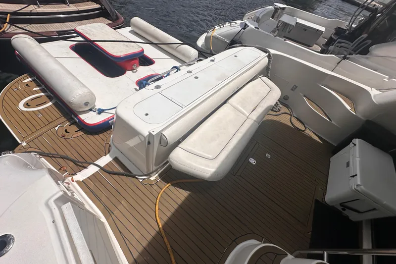 Slide: The Image of 2006 Sea Ray 58 Sedan Bridge yacht deck with seating and water accessories. - 8