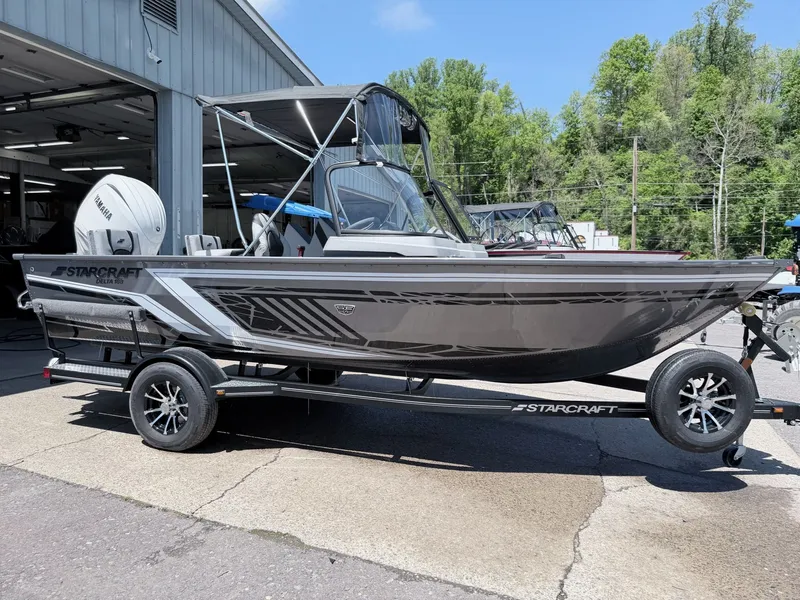 Slide: The Image of Starcraft 188 Delta DC 2026 boat on trailer outside workshop. - 23