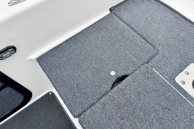Slide: The Image of Carpeted deck of a 2012 Skeeter SL 185 boat, featuring storage compartments. - 21