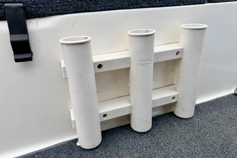 Slide: The Image of White rod holder on a 2012 Skeeter SL 185 boat interior. - 26