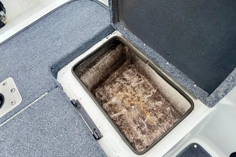 Slide: The Image of Open storage compartment on a 2012 Skeeter SL 185 boat, showing interior details. - 28