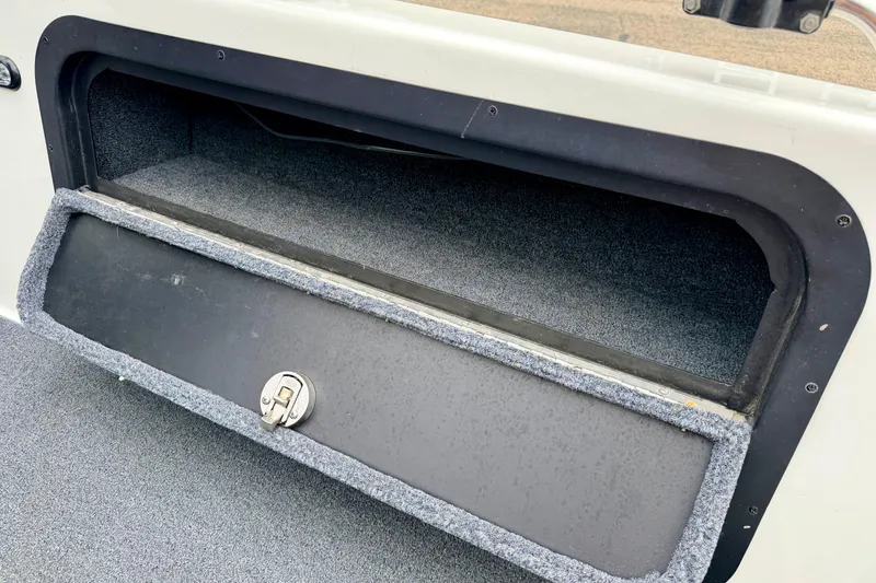Slide: The Image of Storage compartment of a 2012 Skeeter SL 185 boat, featuring a secure latch. - 30