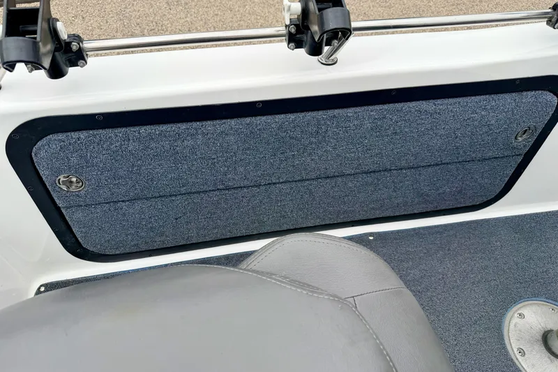 Slide: The Image of Interior view of a 2012 Skeeter SL 185 boat, featuring carpeted storage compartment. - 32