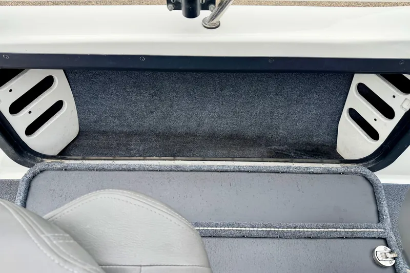 Slide: The Image of Interior view of a 2012 Skeeter SL 185 boat, showcasing storage compartment and seating. - 33